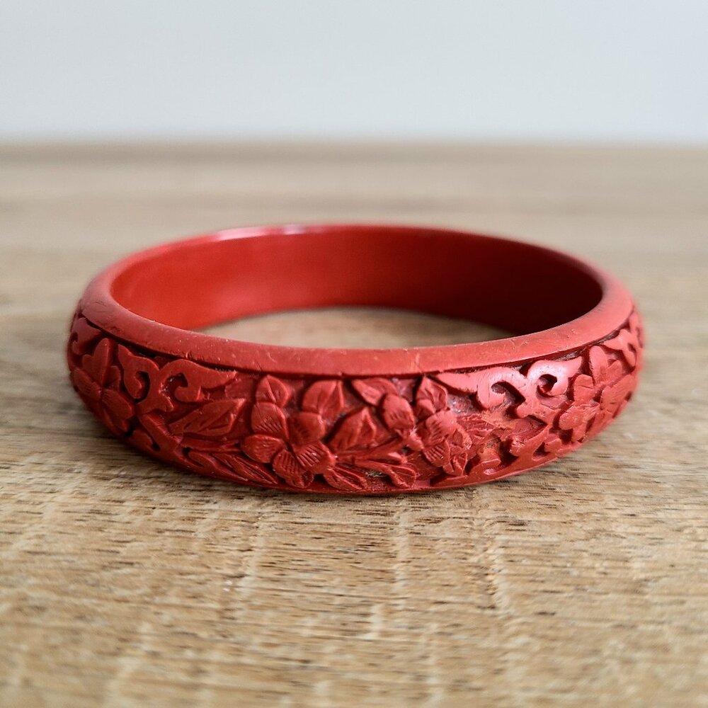 Carved red plastic bangle.